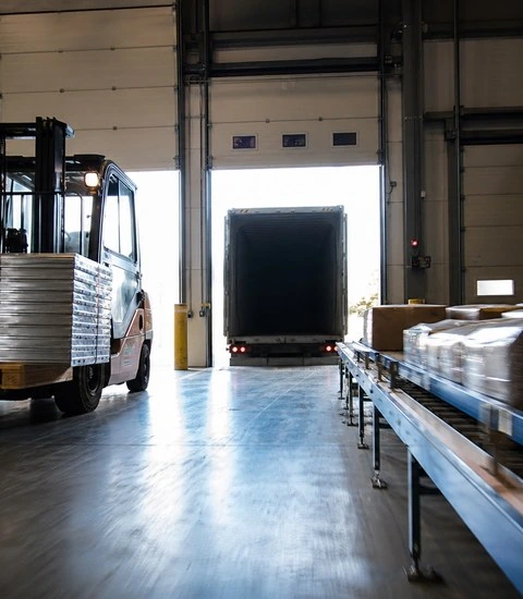 İhracat lojistiği — depo yükleme rampasında forklift ve paletli sevkiyat